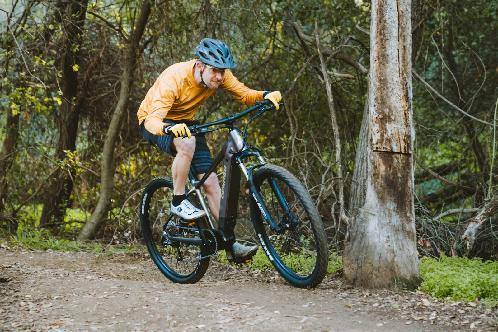 a man riding a bike down a dirt road